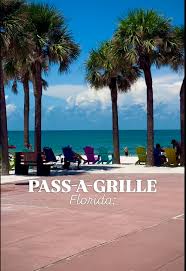 Palm-lined seawall and colorful Adirondack chairs facing the Gulf at Pass-A-Grille