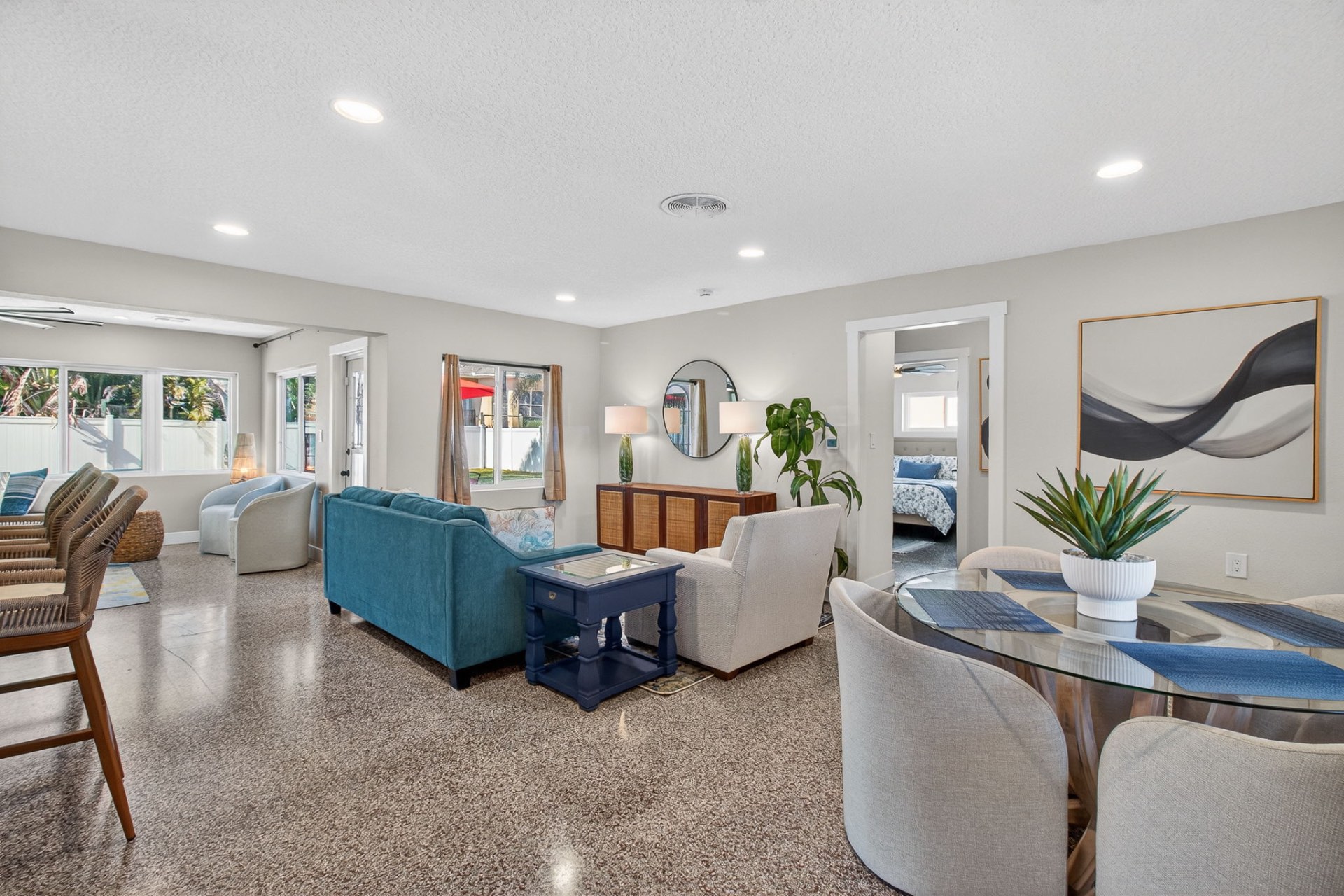 Open-plan living and dining room with terrazzo floors and warm neutrals